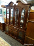 (R1) CHINA CABINET; 2 PC. WOODEN CHINA CABINET. TOP PIECE HAS A BROKEN ARCH PEDIMENT AT THE TOP,