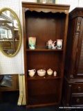 (R2) BOOKCASE; WALNUT, 2-SHELF BOOKCASE WITH A SCALLOPED TOP, REEDED SIDES, AND BRACKET FEET.