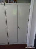 (HALL) BEIGE TENNSCO TWO DOOR METAL STORAGE CABINET WITH 4 METAL SHELVES. TWISTING LATCH HANDLE.