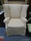 (LEFT WALL) WING CHAIR; MAHOGANY WING CHAIR WITH BEIGE UPHOLSTERY- 33 IN X 35 IN X 40 IN UPHOLSTERY