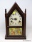 (R2) ANTIQUE MANTEL CLOCK; ANTIQUE GILBERT MAHOGANY CASE STEEPLE CLOCK, METAL DIAL, COLONIAL PRINT