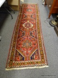 (LEFT WALL) ORIENTAL RUNNER; HAND WOVEN ORIENTAL HAMADAN RUG IN RED, BROWN AND IVORY- 31 IN X 112 IN