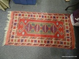 (LEFT WALL) ORIENTAL RUG; HAND WOVEN ORIENTAL RUG IN RED, BLUE AND IVORY GEOMETRIC PATTERNS- 27 IN X