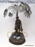 (R1) ANTIQUE LAMP; ANTIQUE SMELTER LAMP OF MIDDLE EASTERN WATER CARRIER, PALM TREE OVER MAN CARRYING