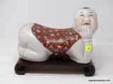 (LEFT WALL) ORIENTAL HEADREST; PORCELAIN ORIENTAL HEADREST ON ROSEWOOD STAND- 12 IN X 6 IN X 10 IN