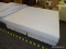 CAL KING FOAM MATTRESS WITH SPLIT BOX SPRING AND METAL BED FRAME.