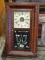 (R2) ANTIQUE CLOCK; 19TH CEN. SETH THOMAS OGEE CLOCK WITH REVERSE PAINTING OF FLOWERS ON DOOR, PAPER