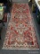 (BACK WALL) ORIENTAL RUNNER; ORIENTAL PERSIAN RUNNER WITH LOTUS PATTERN DESIGN IN RED, IVORY AND