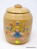 (RIGHT WALL) VINTAGE COOKIE JAR; VINTAGE UNMARKED POTTERY COOKIE JAR WITH EMBOSSED GIRL- 9 IN H