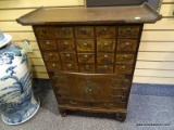 (RIGHT WALL) ORIENTAL CABINET; MAHOGANY ORIENTAL 20 DRAWER SPICE CABINET WITH CARVED SCRIPT ON