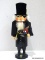(R4) HERR DROSSELMEYER NUTCRACKER WITH A NUTCRACKER ON HIS LEFT AND A STOPWATCH ON HIS RIGHT.