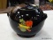 (TABLES) BLACK COOKIE JAR WITH FRUIT ON THE SIDES, 2 HANDLES, AND A LID.
