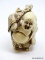 (RFRT) LARGER HAND CARVED FIGURINE; SHOWS A FAT MAN TRAVELING WITH A SACK OVER AND SHOULDER AND