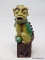 (RFRT) PORCELAIN FOO DOG; GREEN AND YELLOW FOO DOG WITH SPIKES AROUND HIS HEAD AND BACK. LEFT PAW IS