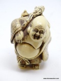 (RFRT) LARGER HAND CARVED FIGURINE; SHOWS A FAT MAN TRAVELING WITH A SACK OVER AND SHOULDER AND