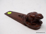 (RFRT) WOODEN FROG DOOR STOP; HAS A HAND CARVED FROG SITTING ON A LILLY PAD ON THE END OF THE WEDGE.