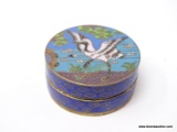 (RFRT) CLOISONNE POWDER BOX WITH A SCENE ON THE LID THAT SHOWS A LARGE BLACK AND WHITE BIRD LANDING
