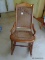(BDRM2) CANE ROCKING CHAIR; CANE BOTTOM AND BACK ROCKING CHAIR WITH AN ARCHED CROWN, BENDING ARMS,