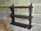 (GARAGE) TIERED WALL SHELF; 3-TIERED, BLACK PAINTED WALL SHELF. MESURES 22.5