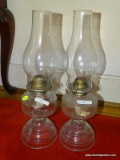 (BACKROOM) PAIR OF VINTAGE OIL LAMPS; 2 PIECE LOT OF CLEAR GLASS OIL LAMPS WITH WICK AND CHIMNEY.