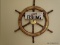 (FAMRM) SHIPS WHEEL; WALNUT AND BRASS SHIP'S WHEEL- 29 IN DIA. AND A GONE FISHING WOODEN PLAQUE- 12