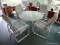 (PORCH) TABLE AND CHAIRS; PATIO TABLE AND 4 CHAIRS- TABLE ALUMINUM AND PLEXIGLASS TABLE- 48 IN DIA.