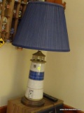 (FAMRM) LAMP; POTTERY LIGHTHOUSE LAMP ON WOODEN BASE WITH CLOTH SHADE- 27 IN H