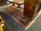 (R3) FLORAL AREA RUG; WOOL PILE AREA RUG WITH A COLORFUL, FLORAL PATTERN ON A RED AND NAVY COLOR