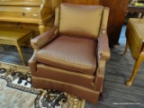 (R2) 1 IN A PAIR OF UPHOLSTERED ARM CHAIRS; SLOPED ARM CHAIR WITH A PURPLE AND GOLD TONED UPHOLSTERY