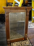 (R1) ANTIQUE MIRROR; MAHOGANY MIRROR WITH A FLARED CORNICE TOP, A GOLD PAINTED INNER RIM, AND CARVED