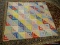 (R4) HANDMADE QUILT; BEAUTIFUL FLORAL QUILT WITH ALTERNATING STRIPS OF COLOR AND FLORAL PATTERNS.