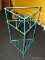 (R7) METAL RACK; TEAL COLORED TRIANGULAR METAL RACK WITH 3 ROUND PLANT HOLDERS AND LOWER SHELF.
