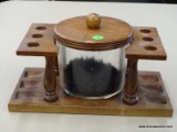 (R3) DUK-IT PIPE STAND WITH 6 PIPE SLOTS AND A LIDDED GLASS TOBACCO JAR.