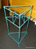 (R7) METAL RACK; TEAL COLORED TRIANGULAR METAL RACK WITH 3 ROUND PLANT HOLDERS AND LOWER SHELF.