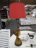 (R7) ROOSTER TABLE LAMP; HEAVY COMPOSITE ROOSTER LAMP WITH ROUND BASE AND DRUM SHAPED RED SHADE.