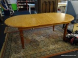 (R8) OVAL KITCHEN TABLE; OAK KITCHEN TABLE WITH DARK FINISHED TURNED POLE LEGS. MEASURES 42