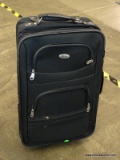 BASS ROLLING SUITCASE AND MAKEUP BAG. SUITCASE HAS AN EXTENDING HANDLE.
