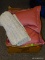 BOX LOT WITH THROW PILLOWS AND A PAIR OF GRAY BATH RUGS.