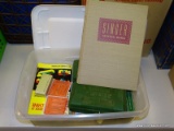 LOT OF ASSORTED SINGER SEWING MACHINE PARTS AND DIRECTION MANUALS.