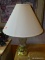 (WALL) TABLE LAMP; CUT GLASS AND POLISHED BRASS TABLE LAMP WITH A CREAM FABRIC COOLIE SHADE.