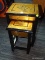 (R2) NESTING TABLE; 2 PIECE SET OF BLACK FINISHED NESTING TABLES WITH A GOLD TONED TOP AND A FLORAL