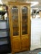 (R4) OAK CABINET; TALL DISPLAY CABINET WITH 2 UPPER BEVELED GLASS DOORS, REVEALS A STORAGE AREA WITH