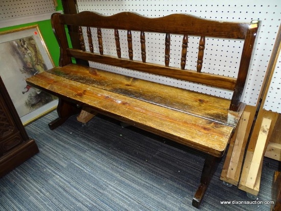 (WALL) WALNUT BENCH; RUSTIC BENCH WITH A BANNISTER BACK AND HOUR GLASS SHAPED LEGS. MEASURES 55.5" X