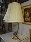 (WALL) TABLE LAMP; CUT CRYSTAL TABLE LAMP WITH A POLISHED BRASS BASE AND A DRUM/COOLIE SHADE.