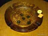 (R2) AMBER GLASS ASH TRAY WITH A WAVE TEXTURED BOTTOM. HAS A 6.5