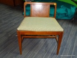 (R2) SHORT STOOL; WALNUT STOOL WITH A GREEN LEAF PATTERNED UPHOLSTERED SEAT, A WATERFALL STYLE BACK,