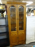 (R4) OAK CABINET; TALL DISPLAY CABINET WITH 2 UPPER BEVELED GLASS DOORS, REVEALS A STORAGE AREA WITH