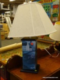 (R4) TABLE LAMP; BOX SHAPED, WOODEN TABLE LAMP WRAPPED WITH A BLUE TONED HUNT SCENE. COMES WITH A