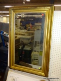 (BWALL) VINTAGE MIRROR; WALL HANGING MIRROR WITH A GOLD TONED FINISHED WOODEN FRAME. FINISH HAS