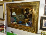 (BWALL) BEVELED MIRROR; FRAMED, WALL HANGING MIRROR WITH A BEVELED EDGE AND AN ORNATE GOLD TONED